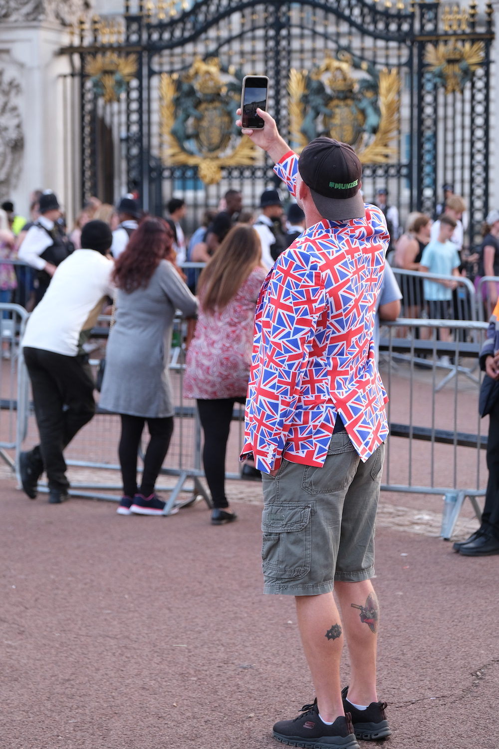 Patriotic man in a Union Jack jacket outside Buckingham Palace